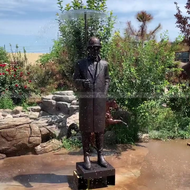 estatua de hombre con fuente de paraguas