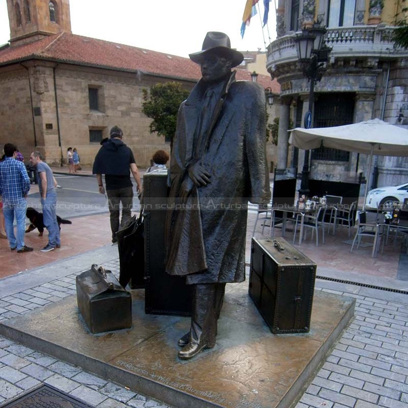 Skulptur eines Mannes mit Koffer