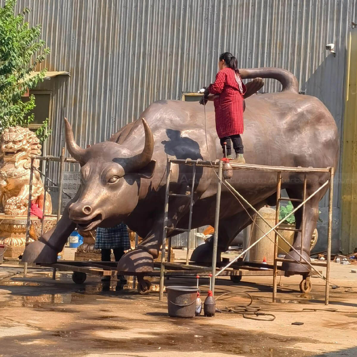 Big Bull Wall Street sculpture being polished