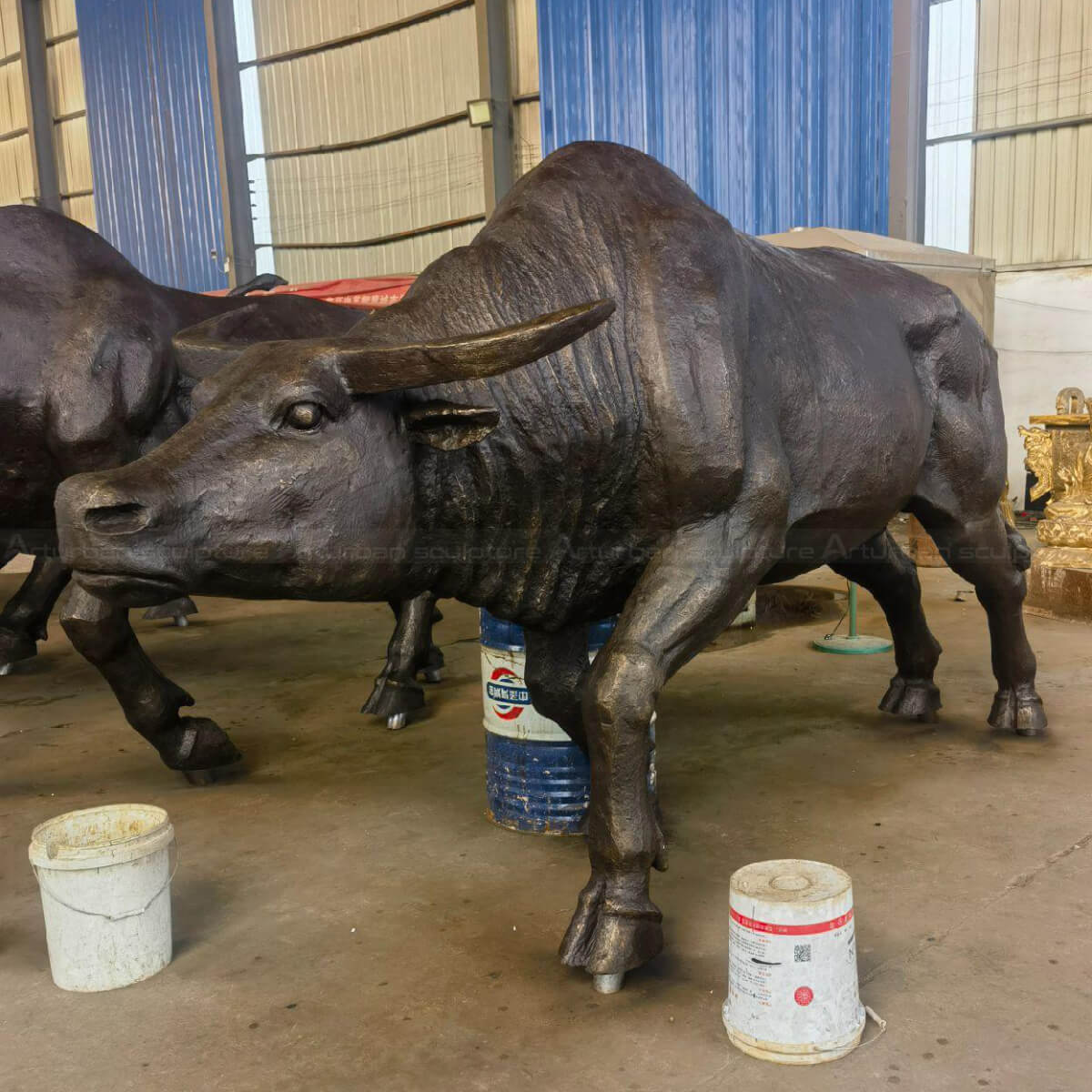 Bronze Bull sculpture with lowered head, preparing for an attack