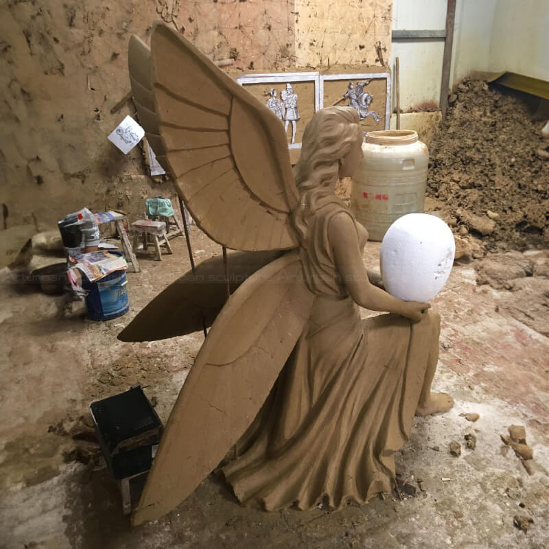 Clay mold of angel statue holding an egg