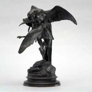 a bird of prey capturing a heron statue front view