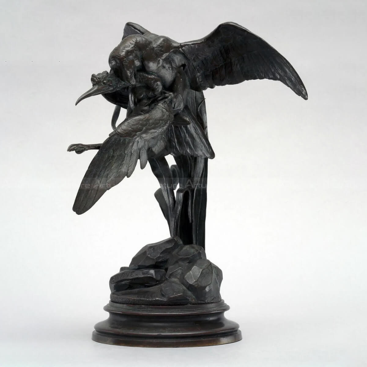 a bird of prey capturing a heron statue front view