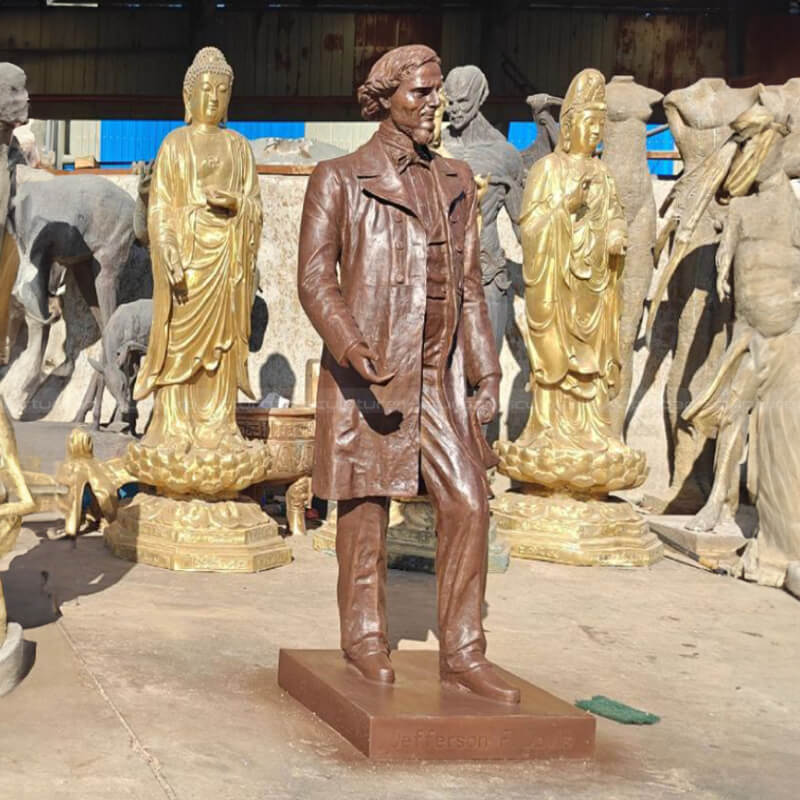 bronze Statue of Davis standing and holding a scroll in his right hand