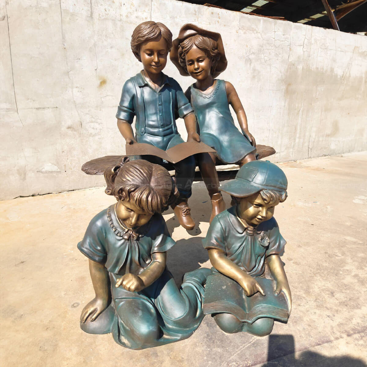 four Children Reading and interacting Statue
