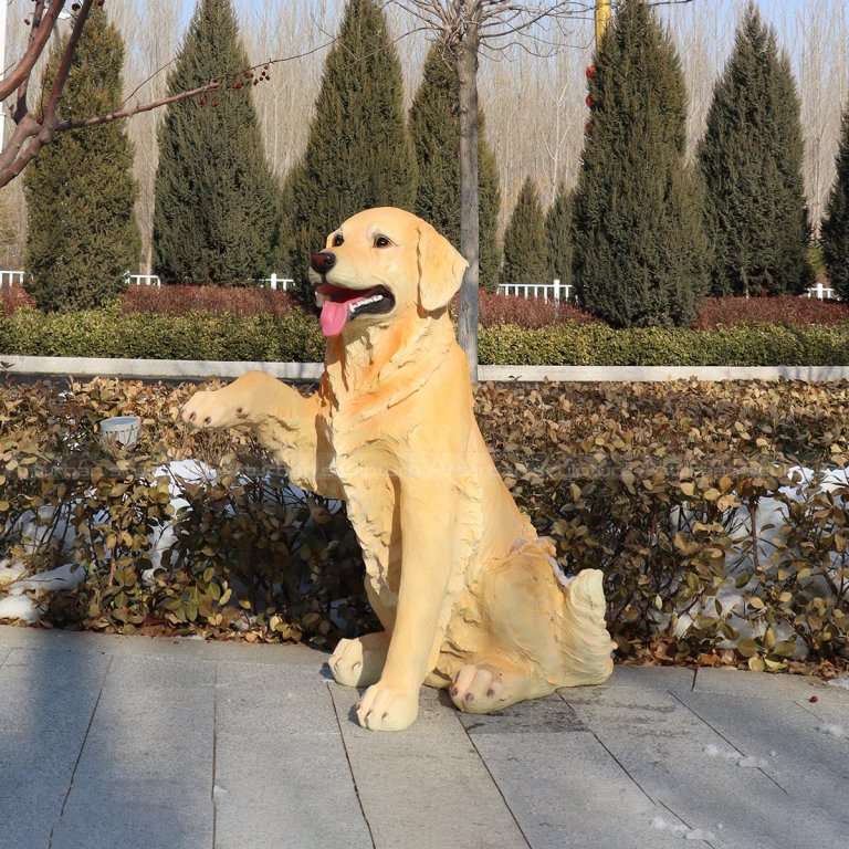 resin golden retriever statue with one front paw raised
