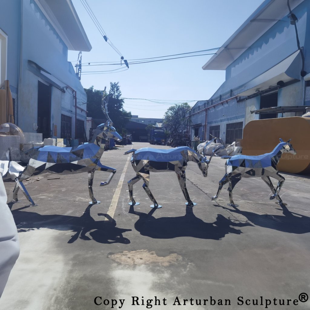 A group of geometric stainless steel deer sculptures