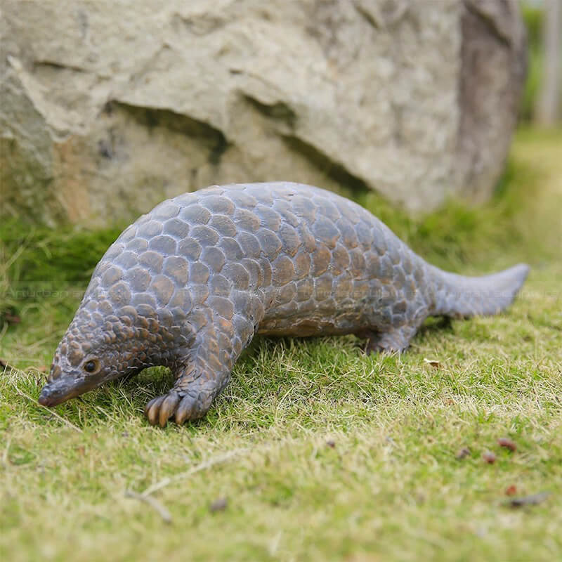 Pangolin Statue crawling slowly with its head down and tail stretched out