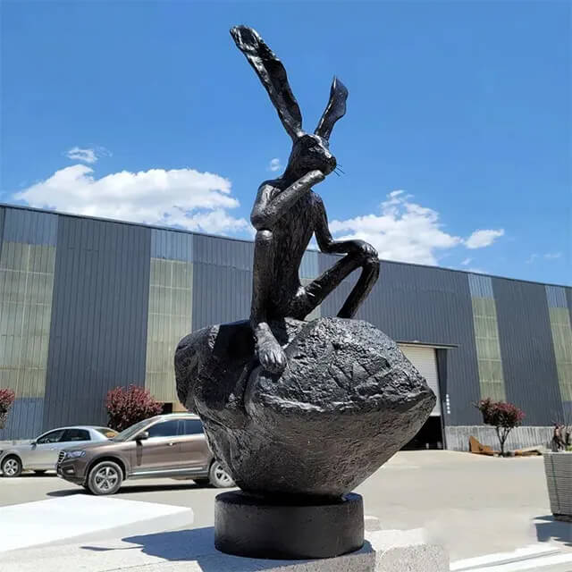 side view of Barry Flanagan Hares deep in thought bronze statue for Sale