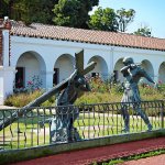 Bronze Passion of Christ Statue depicting Jesus carrying the cross while being guarded by a Roman soldier