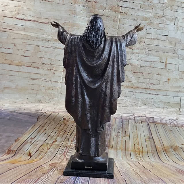 Rear view of the Bronze Statue of Jesus with long detailed hair and extended arms