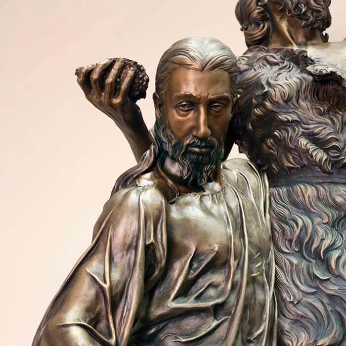 Close-up of Christ's face in bronze Baptism Statue