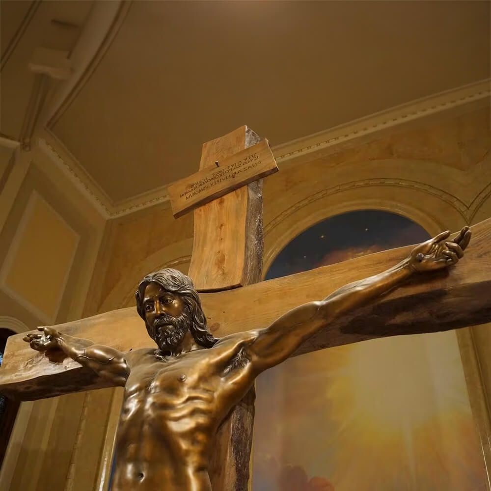 bronze Statue of Crucifixion showing Latin inscription and upper torso detail