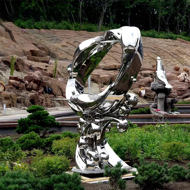 Stainless steel Dolphin Outdoor Statue featuring three long-snouted dolphins forming a hollow circular ring