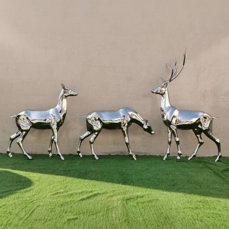 A group of Stainless Steel Deer Sculptures featuring one stag with antlers and two does