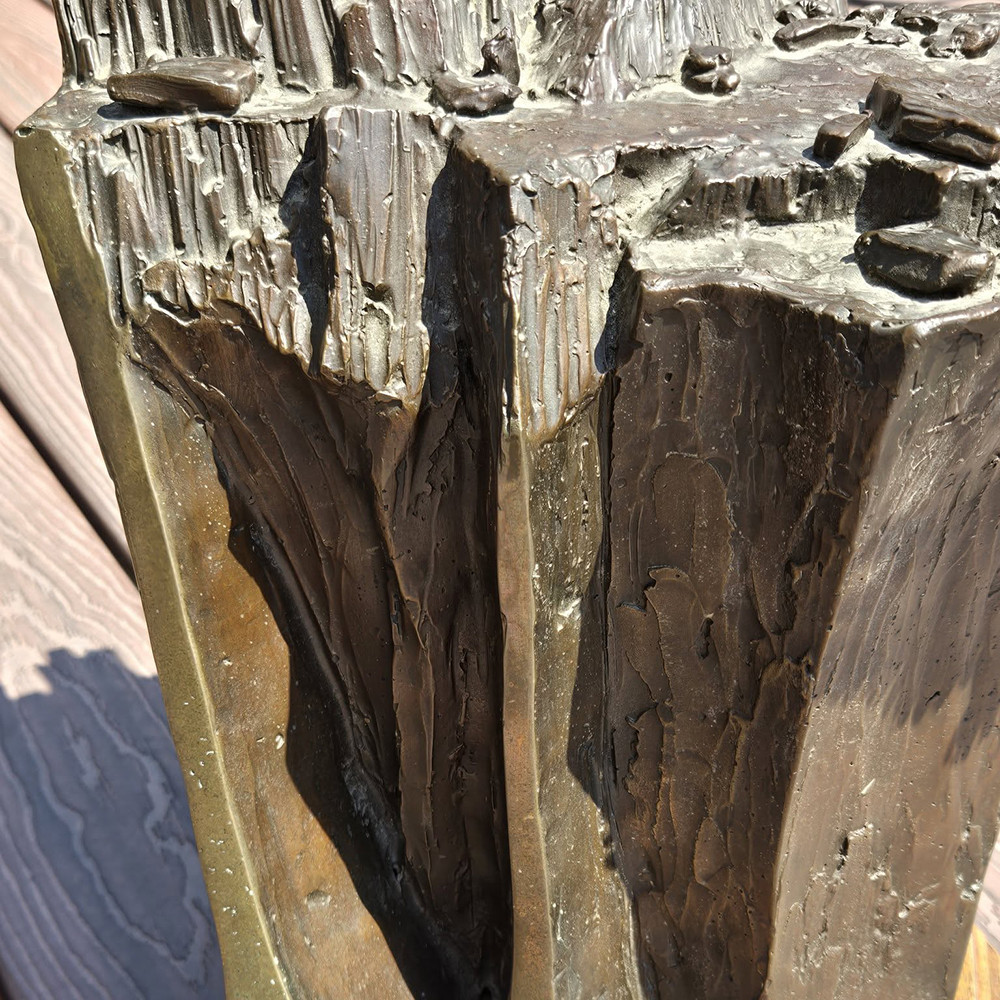 Close-up of Bronze Eagle Bird Statue highlighting rocky texture and details