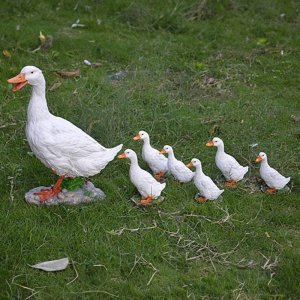 Gartendekorationen aus der Entefamilie aus Fiberglas, die eine Mutterente zeigen, die ihre Entenküken führt