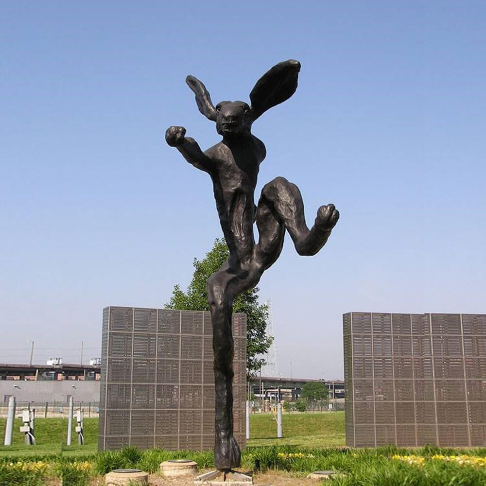 Outdoor Hare Sculpture in bronze titled Nijinski Hare, showing a hare standing on one leg with raised arms inspired by ballet