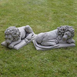 Paar marmorener Schlafender Löwenstatuen auf Gras platziert