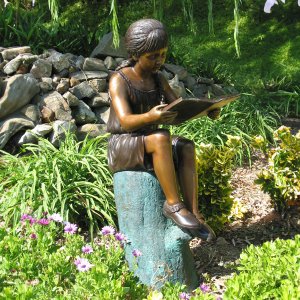 Bronze Girl Reading Book Statue in garden