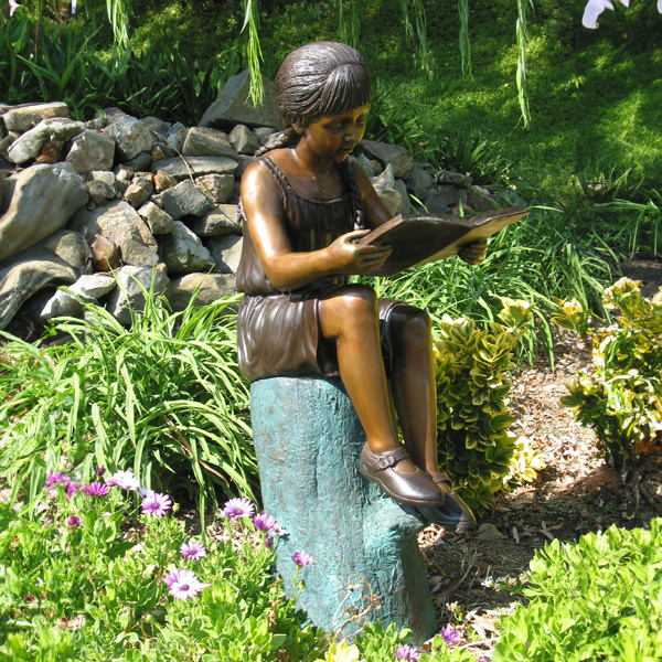 Bronze Girl Reading Book Statue in garden