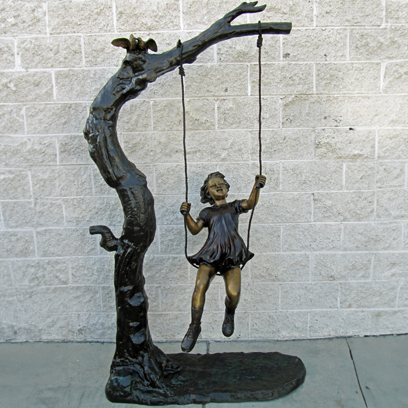 Bronze Girl on Swing Statue under tree
