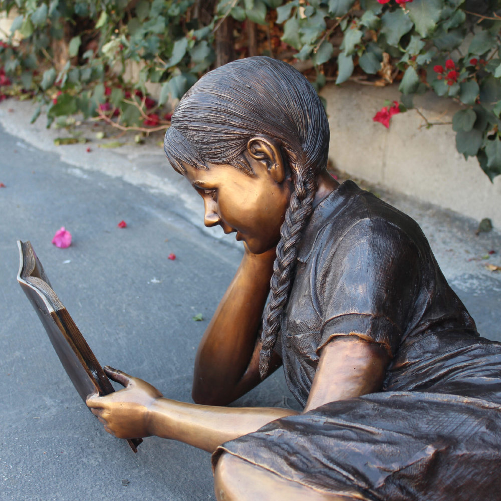 Bronze Sculpture Girl Reading book close-up view