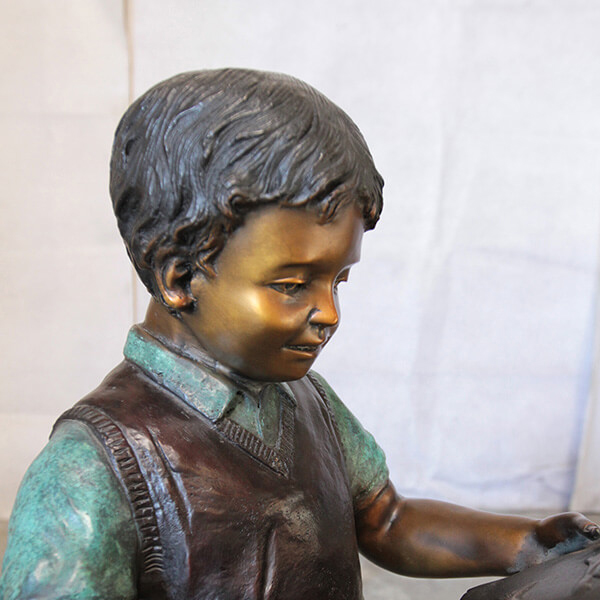 Close-up bronze Boy Reading Statue portrait