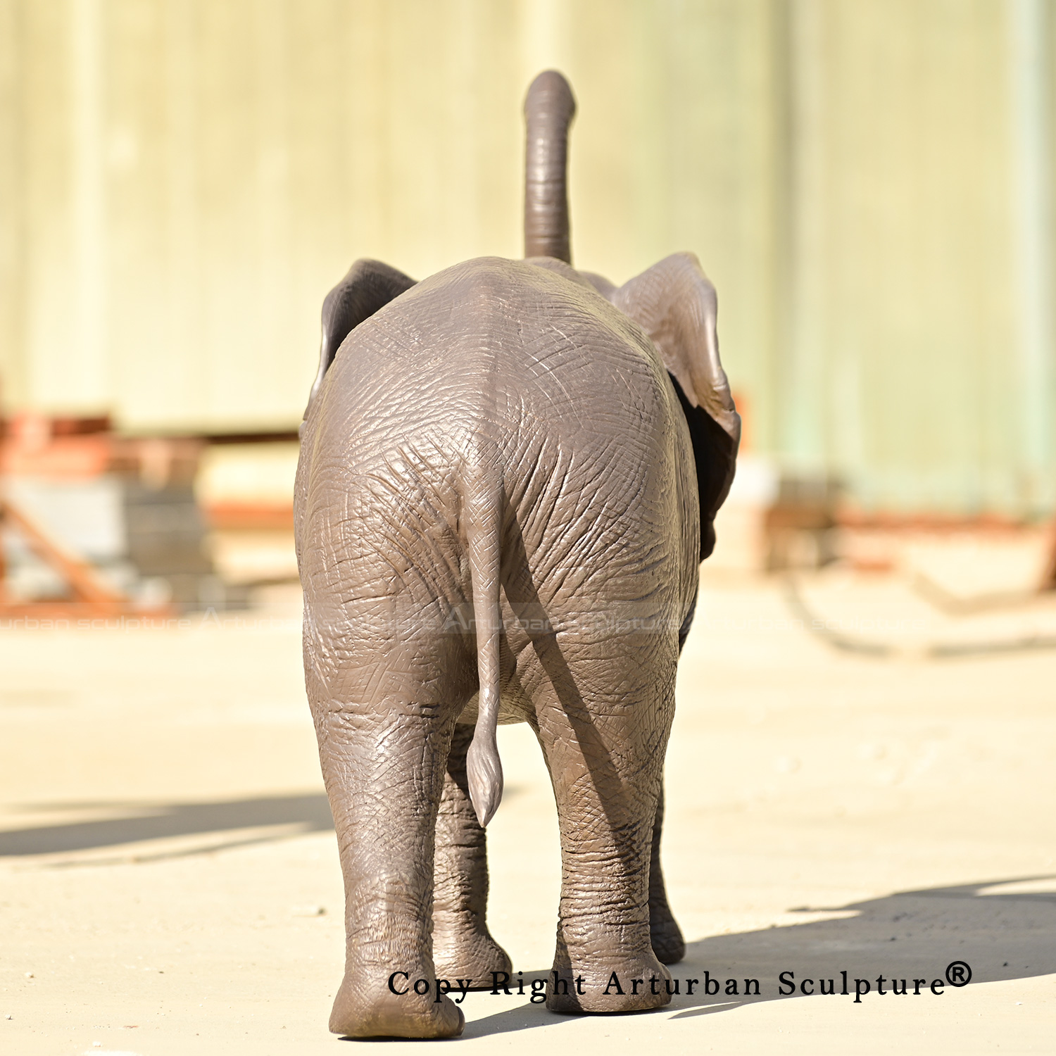 3 Rear view of walking bronze African elephant