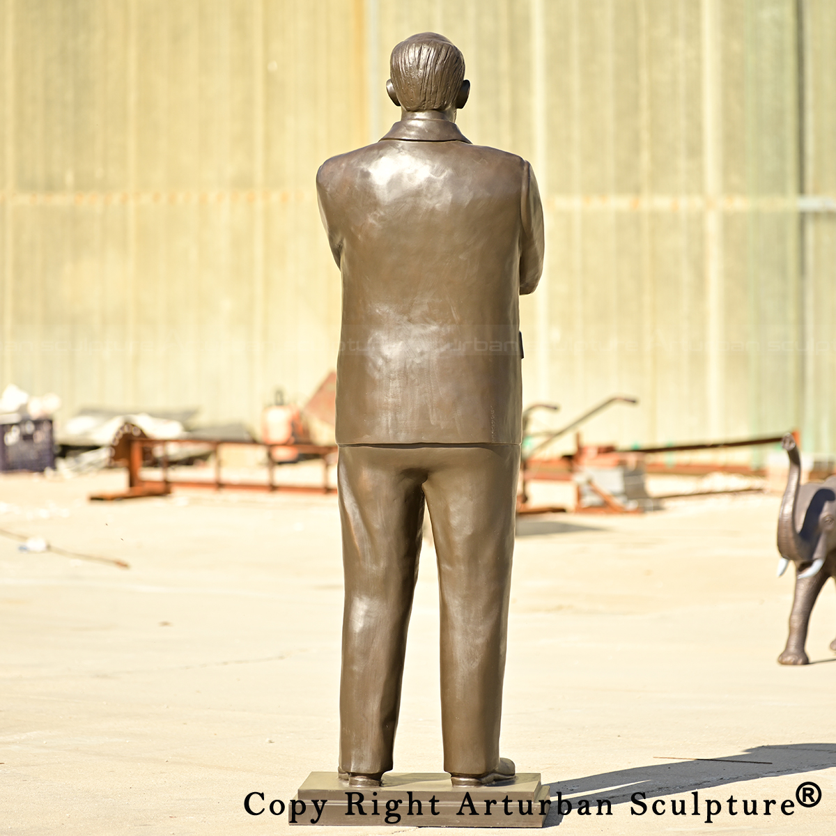 4 Rear view of bronze historical figure statue
