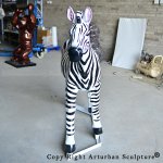 3 Fiberglass zebra sculpture beside wild kong statue