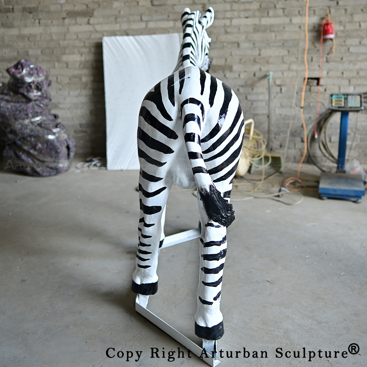 7 Back view of fiberglass zebra statue on stand