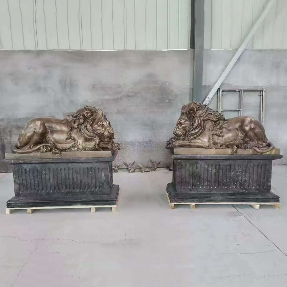Bronze Reclining Lion Statue pair on pedestals