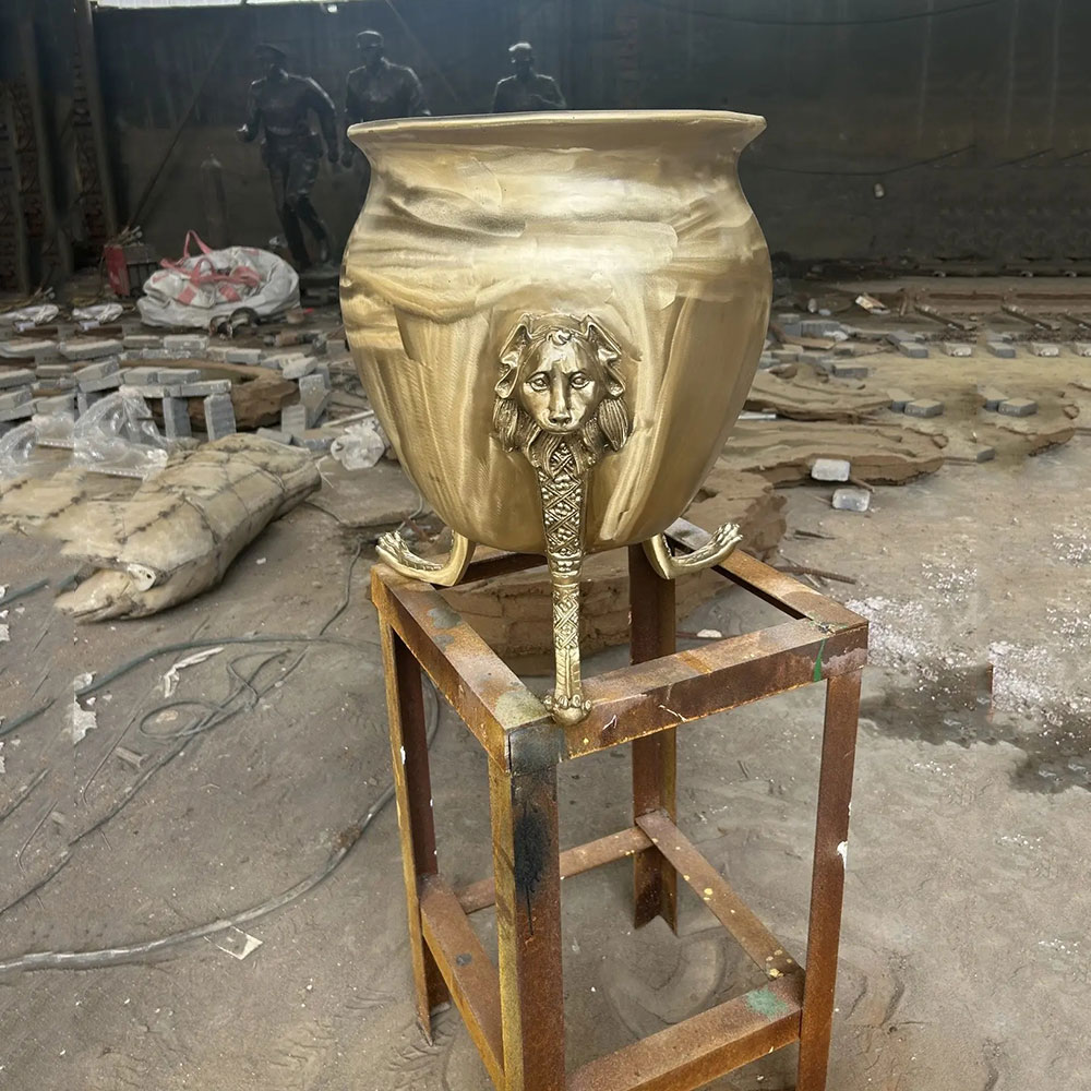 Bronze garden urns with lion head supports