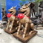 Bronze qilin sculpture pair in seated pose