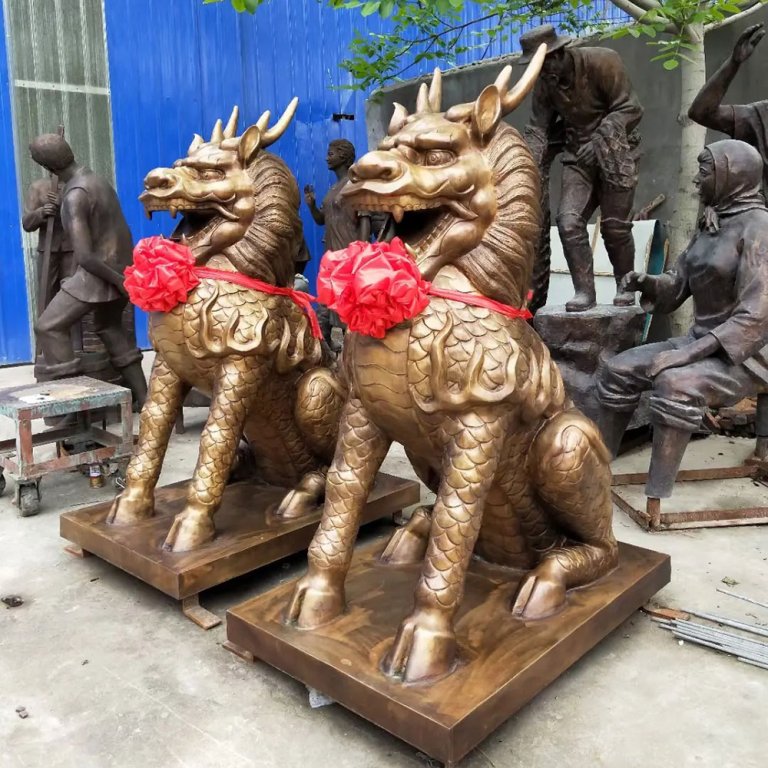 Bronze qilin sculpture pair in seated pose
