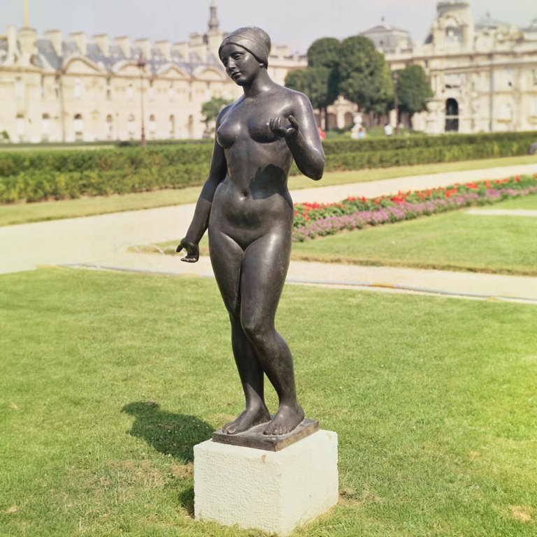 Statua di Donna Nuda in Bronzo in un Ambiente da Giardino
