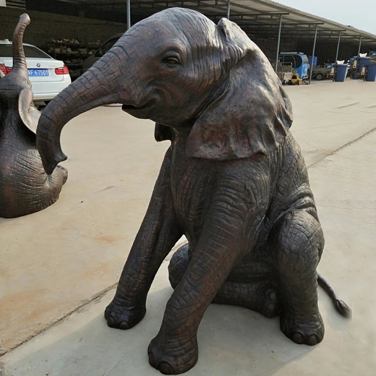 Seated Baby Elephant Statue with Curved Bronze Trunk