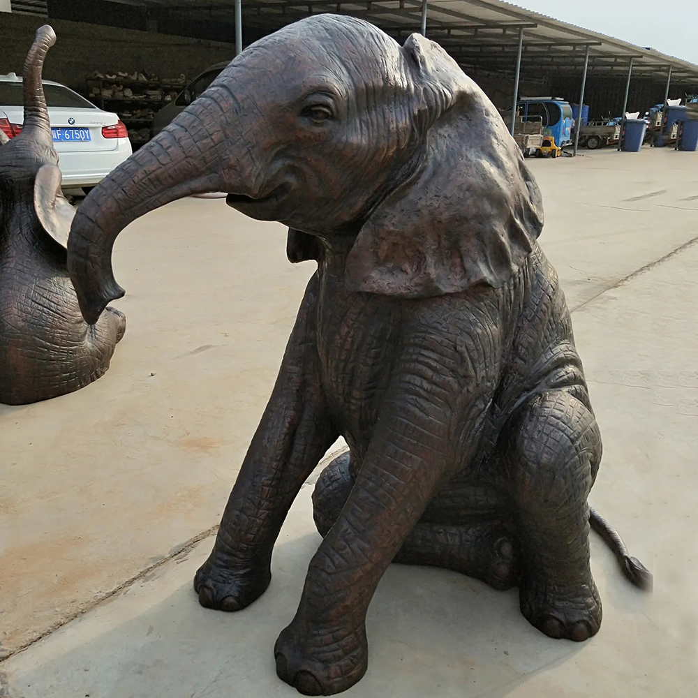 Seated Baby Elephant Statue with Curved Bronze Trunk