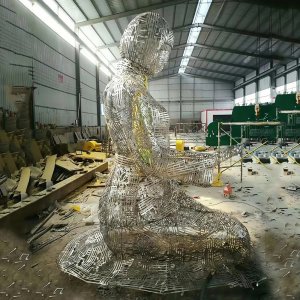 Stainless steel kneeling woman sculpture with latticework